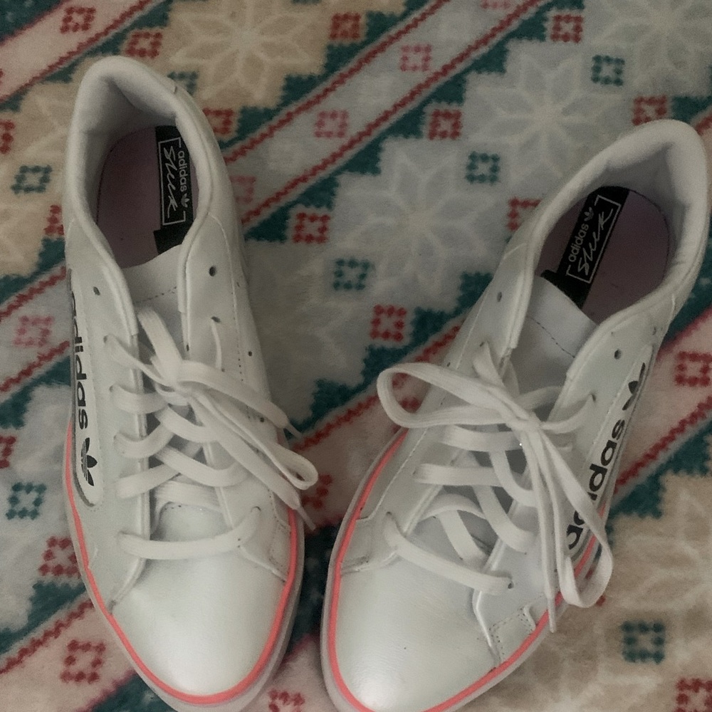 white ADIDAS sneakers with neon orange stripe